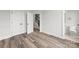 Spacious bedroom featuring wood-look floors, multiple doors, and ample natural light at 4011 Tundra Rd, Charlotte, NC 28203