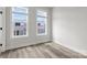 Sun-filled bedroom with wood floors and windows showcasing the exterior community at 4011 Tundra Rd, Charlotte, NC 28203