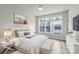 Bright bedroom with modern ceiling fan, bench, and natural light through the windows at 4011 Tundra Rd, Charlotte, NC 28203