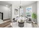 Dining room with large round marble table and grey upholstered chairs at 4011 Tundra Rd, Charlotte, NC 28203