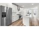Bright, modern kitchen features stainless steel appliances, white cabinetry, and an island with bar seating at 4011 Tundra Rd, Charlotte, NC 28203