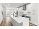 Modern kitchen with stainless steel appliances, white cabinets, quartz countertops, and wood flooring at 4011 Tundra Rd, Charlotte, NC 28203