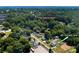 Aerial view of property and neighborhood near downtown Belmont with mature trees at 407 Orchard Ln, Belmont, NC 28012
