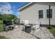 Cozy back patio with outdoor seating, including rocking chairs and a fire pit, perfect for relaxing at 407 Orchard Ln, Belmont, NC 28012