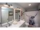 Modern bathroom featuring double sinks, decorative mirrors, and a unique highland cow shower curtain at 407 Orchard Ln, Belmont, NC 28012