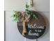 Charming front door decor with a 'Welcome To Our Home' sign, complemented by greenery and a ribbon at 407 Orchard Ln, Belmont, NC 28012