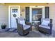 Inviting front porch with comfortable seating, featuring two swivel chairs and a small decorative table at 407 Orchard Ln, Belmont, NC 28012