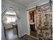 Hallway with a rustic sliding barn door leading to a bathroom and kitchen in the background at 407 Orchard Ln, Belmont, NC 28012