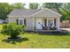 Charming single-story home with a cozy front porch, well-maintained lawn, and mature landscaping at 407 Orchard Ln, Belmont, NC 28012