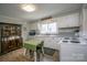 Traditional kitchen with white cabinets, wood floors, and eat-in dining area at 407 Orchard Ln, Belmont, NC 28012