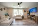 Comfortable living room with wood flooring, modern ceiling fan, and entertainment center at 407 Orchard Ln, Belmont, NC 28012