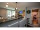 Open living area with bar seating and view into updated bathroom at 407 Orchard Ln, Belmont, NC 28012