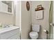 Clean bathroom with white sink, toilet, and decorative accents at 413 Picadilly Ln, Troutman, NC 28166