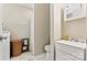 Bright bathroom with white marble floors, vanity, and washer/dryer at 413 Picadilly Ln, Troutman, NC 28166