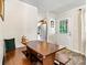 Eat-in dining area with a wooden table, bench seating, and a view of the home's entrance at 413 Picadilly Ln, Troutman, NC 28166