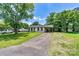 Charming home featuring a white brick exterior, a convenient carport, and a well-manicured lawn at 413 Picadilly Ln, Troutman, NC 28166