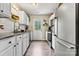 Bright kitchen featuring stainless steel appliances, granite counters, and classic white cabinets at 413 Picadilly Ln, Troutman, NC 28166