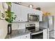 Another view of the kitchen highlights the modern appliances and subway tile backsplash at 413 Picadilly Ln, Troutman, NC 28166