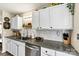 Close-up view of the updated kitchen with granite countertops, subway tile backsplash, and stainless steel appliances at 413 Picadilly Ln, Troutman, NC 28166