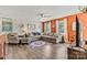 Comfortable living room featuring a large sectional sofa, area rug, and neutral color palette accented by an orange wall at 413 Picadilly Ln, Troutman, NC 28166
