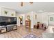 Open-concept living area featuring wood-look flooring, modern entertainment center, and stylish decor at 413 Picadilly Ln, Troutman, NC 28166