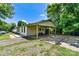 Rear exterior of a white brick home featuring a spacious carport and well-kept backyard at 413 Picadilly Ln, Troutman, NC 28166
