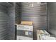 Basement area needing repair with wood paneling and exposed brick at 417 S Broad St, Gastonia, NC 28052