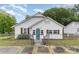 Charming exterior of home with white siding, blue front door, and fenced yard at 417 S Broad St, Gastonia, NC 28052