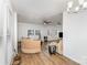 Open-concept living room with hardwood flooring, neutral sofa, and ample natural light at 417 S Broad St, Gastonia, NC 28052