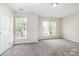 Sun-filled bedroom with neutral walls, plush carpeting, and multiple windows offering ample natural light at 4213 Coulter Xing, Charlotte, NC 28213