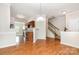 Open dining area featuring hardwood floors and kitchen access with stairway to the right at 4213 Coulter Xing, Charlotte, NC 28213