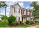 Inviting home exterior with a well-manicured lawn and red brick and siding accents at 4213 Coulter Xing, Charlotte, NC 28213