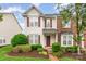 Charming two-story home with a well-maintained lawn, mature landscaping, and red shutters at 4213 Coulter Xing, Charlotte, NC 28213