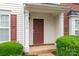 Close-up of the front porch featuring a wood door, white columns, and house number at 4213 Coulter Xing, Charlotte, NC 28213