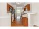 Galley kitchen features wood cabinets, stainless steel appliances, and hardwood floors at 4213 Coulter Xing, Charlotte, NC 28213