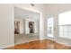 Open-concept living room featuring hardwood floors and large windows with natural light at 4213 Coulter Xing, Charlotte, NC 28213