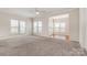 Spacious living room featuring large windows and neutral-colored carpet at 4213 Coulter Xing, Charlotte, NC 28213