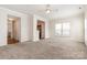 Comfortable living room featuring large windows and open access to the kitchen and hallway at 4213 Coulter Xing, Charlotte, NC 28213