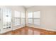 Bright sunroom with wood floors, a door to outside, and multiple windows with shades at 4213 Coulter Xing, Charlotte, NC 28213