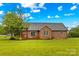 Brick home exterior showcasing a spacious backyard with a deck and pergola at 4336 Hunter Rhyne Rd # 9, Lincolnton, NC 28092
