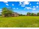 A sprawling green backyard shows a brick home with a wooden deck and pergola at 4336 Hunter Rhyne Rd # 9, Lincolnton, NC 28092