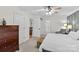 A well-lit bedroom features a ceiling fan, a gray chair, and an ensuite bathroom with a glass-doored shower at 4336 Hunter Rhyne Rd # 9, Lincolnton, NC 28092