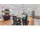 Open floor plan featuring a stone fireplace, hardwood floors, and a modern kitchen with white cabinets at 4336 Hunter Rhyne Rd # 9, Lincolnton, NC 28092