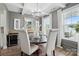 Elegant dining room featuring a stylish chandelier, large windows, and comfortable seating at 4842 Durneigh Dr, Kannapolis, NC 28081