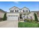 Charming two-story home featuring a welcoming front porch, attached two-car garage, and well-maintained landscaping at 4842 Durneigh Dr, Kannapolis, NC 28081