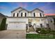 Charming two-story home featuring a welcoming front porch, attached two-car garage, and well-maintained landscaping at 4842 Durneigh Dr, Kannapolis, NC 28081