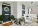 Inviting front porch featuring rocking chairs, decorative wreath, and charming decor at 4842 Durneigh Dr, Kannapolis, NC 28081