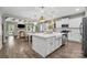 Open-concept kitchen featuring a large island, stainless steel appliances, and hardwood floors at 4842 Durneigh Dr, Kannapolis, NC 28081