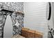 Charming laundry room with decorative wallpaper, shiplap walls, ironing board and wooden storage baskets at 4842 Durneigh Dr, Kannapolis, NC 28081