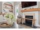 Living room with fireplace, natural wood mantel, and decorative shelving at 4842 Durneigh Dr, Kannapolis, NC 28081